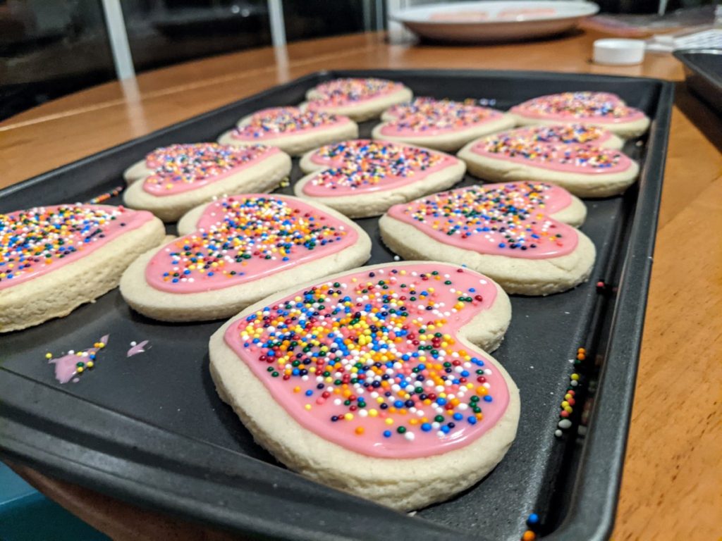 finished heart-shaped sugar cookies with icing and sprinkles