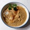 Chicken soup in a bowl over rice