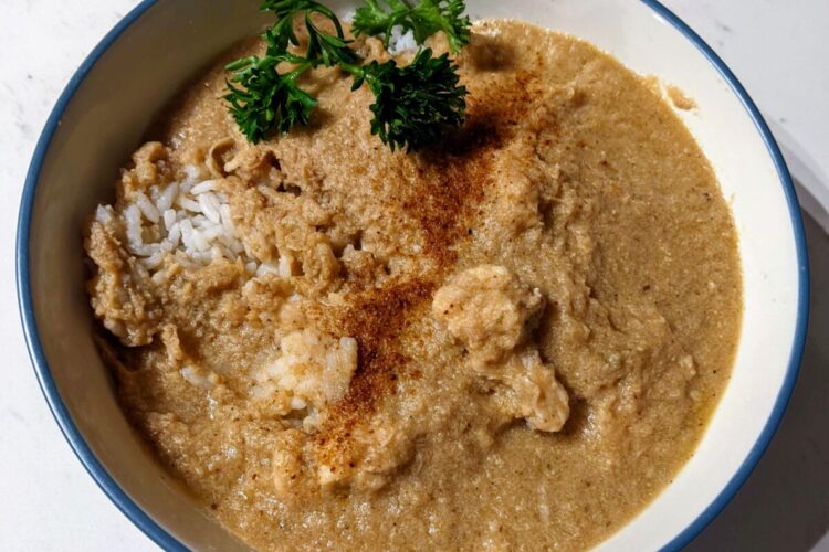 Chicken soup in a bowl over rice