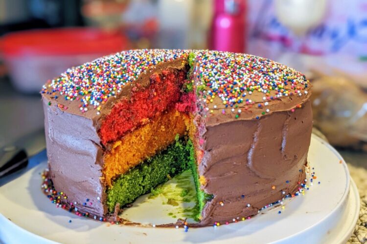 "Rainbow Cookie" cake with a slice cut out